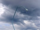 a lamp post and thunder clouds